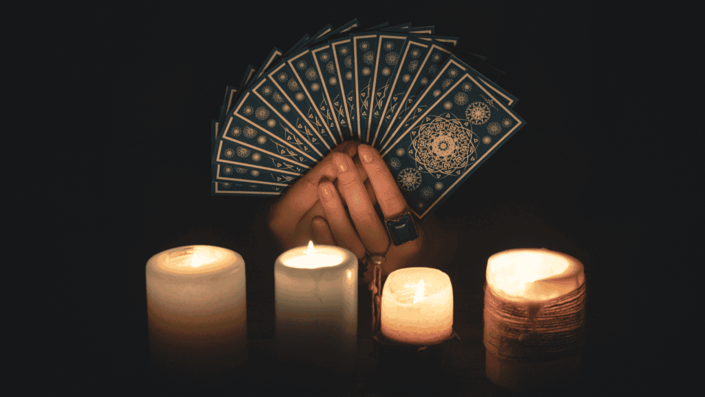 Psychic medium Daksh holding tarot cards reading for spiritual guidance and insight.