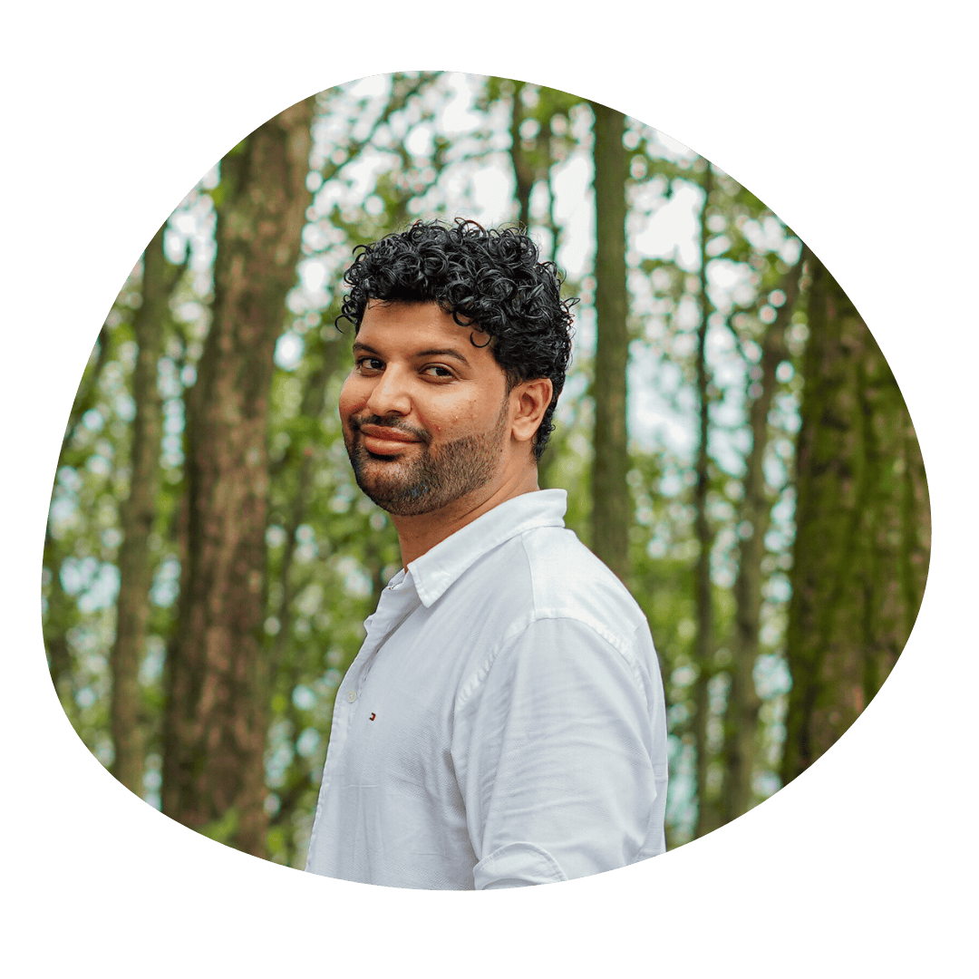 Psychic Medium Daksh offering spiritual guidance and mediumship services in a forest setting.