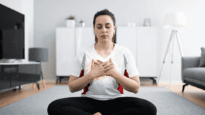 Woman meditating at home, practicing psychic awareness and spiritual connection.