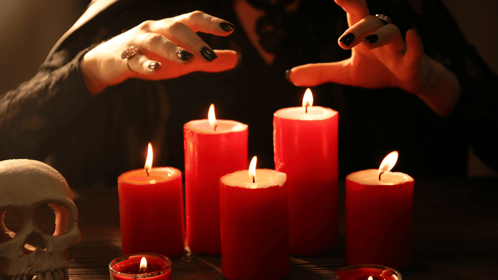 Psychic Energy Woman performing candle ritual with red candles for spiritual energy and psychic connection.