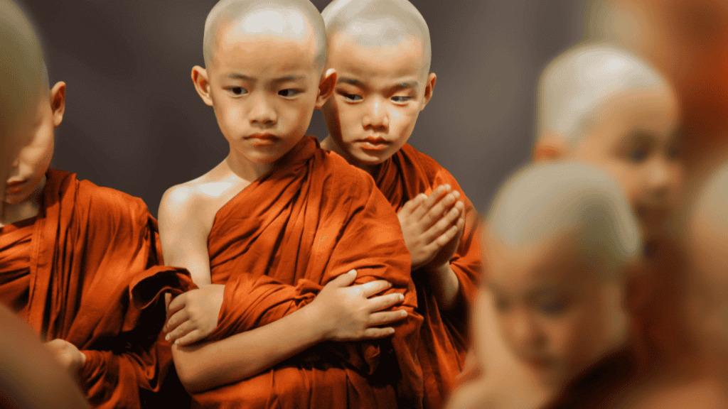 Young monks meditating, emphasizing spiritual importance of gurus in life.